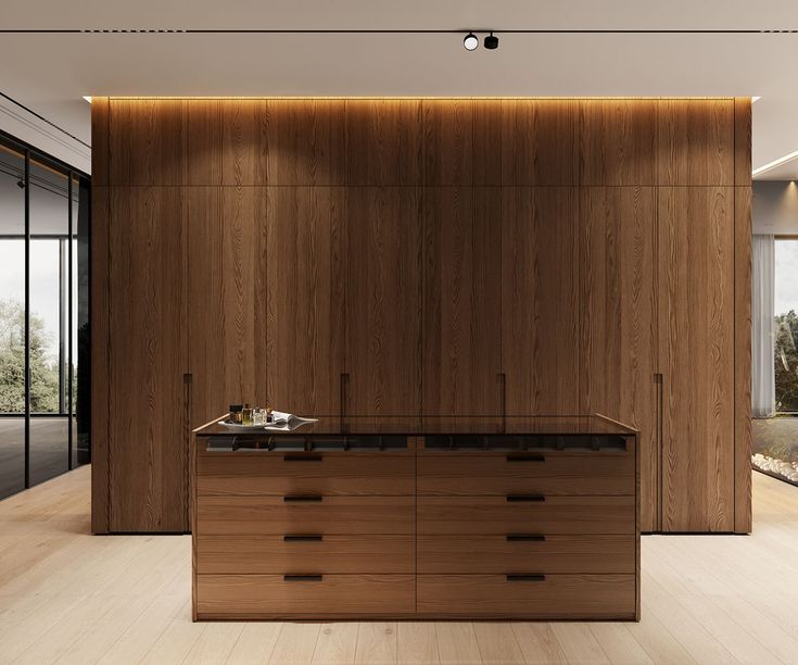 A kitchen with marble counter tops and stainless steel appliances on the wall, along with hanging lights hanging from the ceiling over the ceiling in front of a wooden counter top of a white counter top oven and white